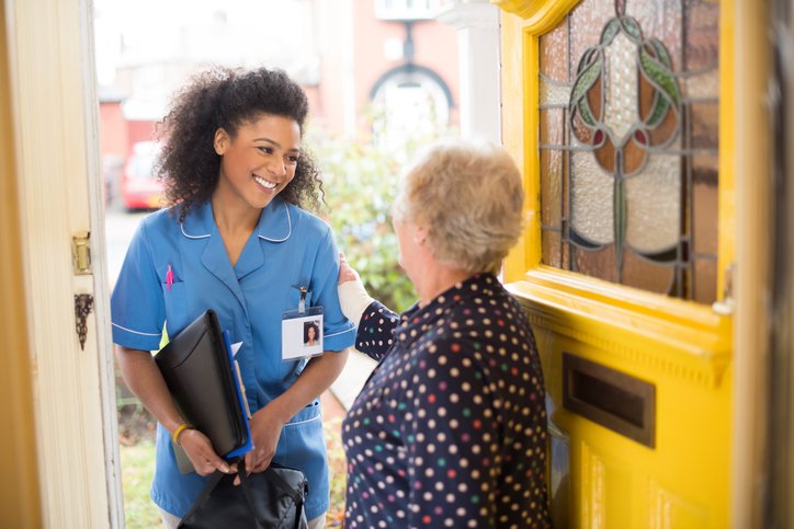 nurse arriving at home of senior patient