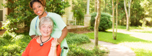 senior patient and caregiver in front yard